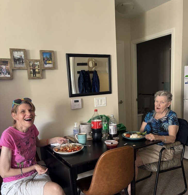 Two senior members smiling